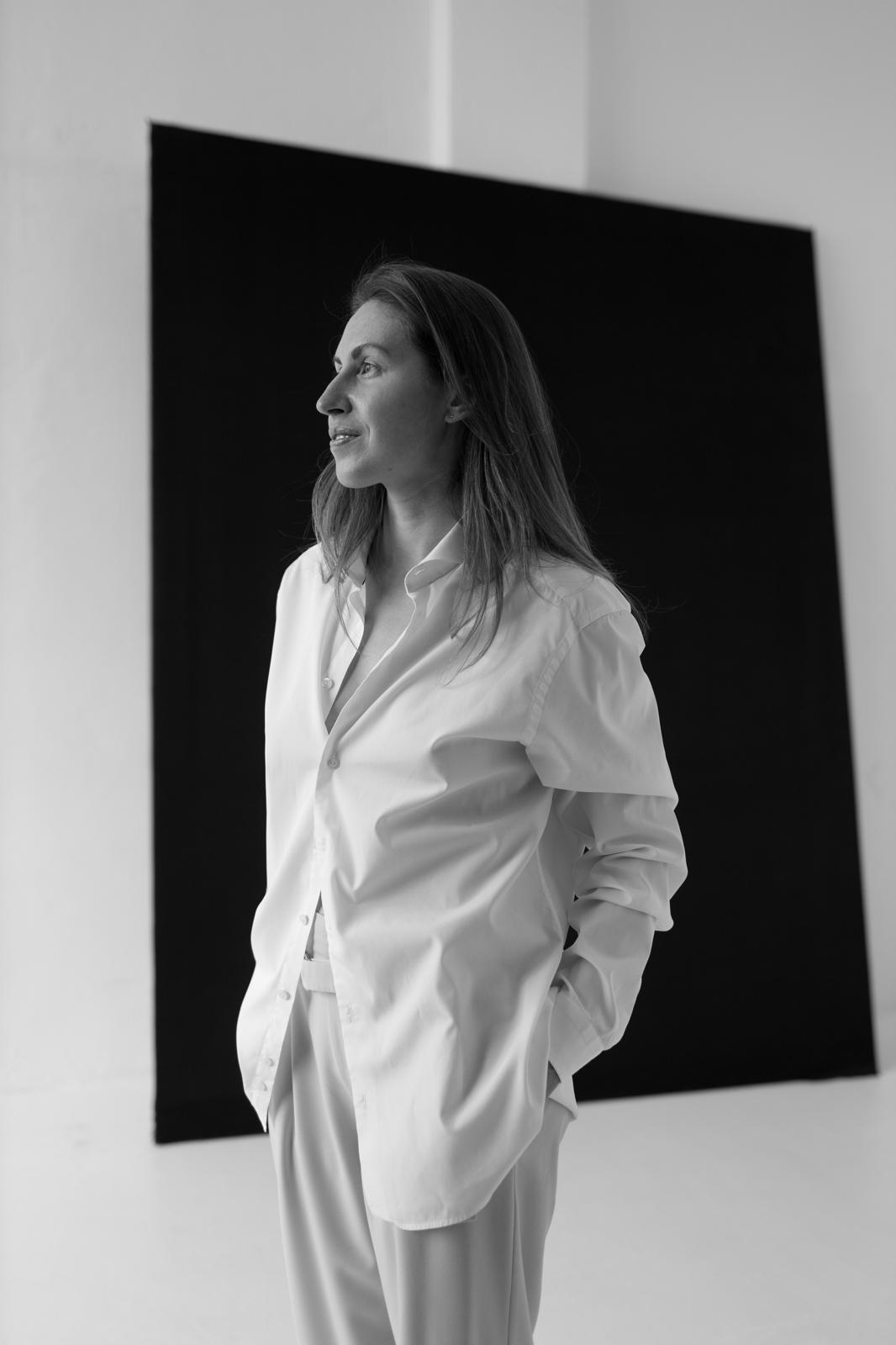Black-and-white portrait of Alexandra Zhukova in a gallery-like interior