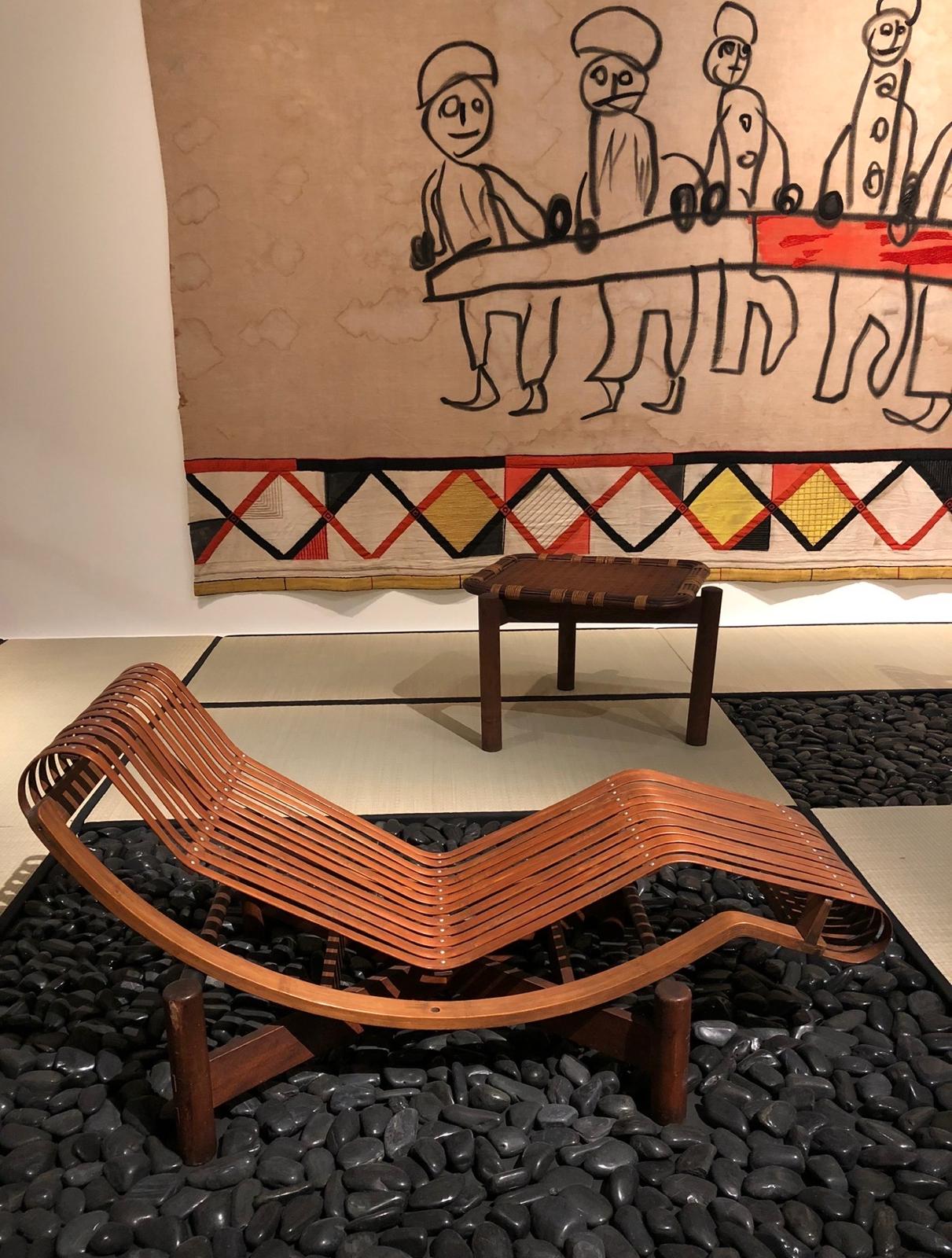 Collectible wooden chaise longue displayed in a refined residential interior