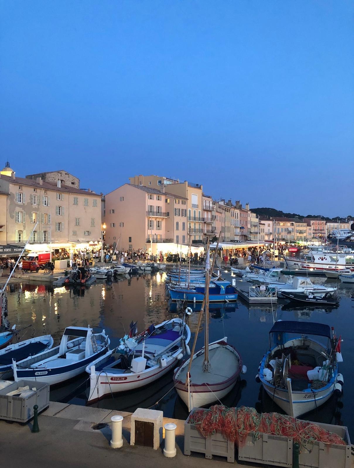 Evening harbor on the French Riviera with moored boats and waterfront buildings
